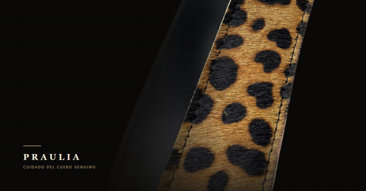 Detalle macro de un cinturón de cuero Praulia: pelo animal print, costura y canto de cuero negro